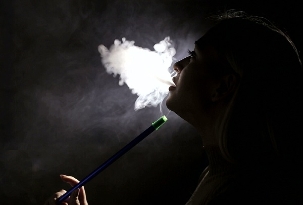 The girl smokes a hookah